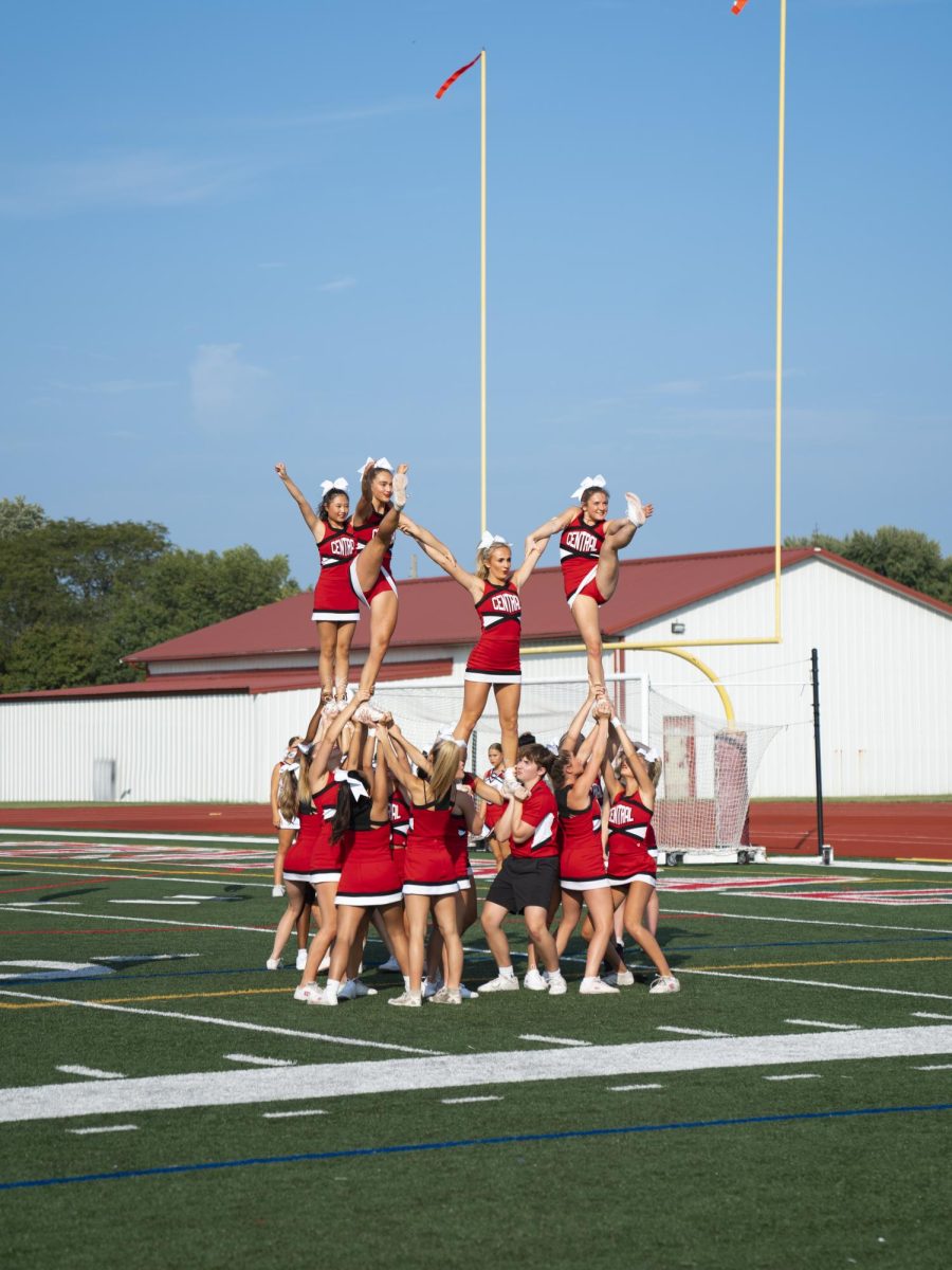 Varsity sideline cheer team performs stunts before the headline varsity soccer game. (Photo illustration)
