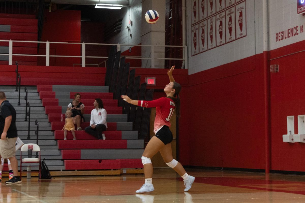 Heidi Cofran, a junior, serves the ball during the JV volleyball scrimmage in Central’s main gym. 
