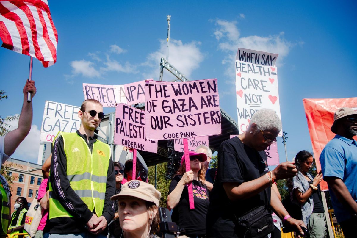 Protesters from Code Pink hold signs reading "REJECT AIPAC" on Monday, Aug. 19. AIPAC is the largest pro-Israel lobbying group in the U.S.