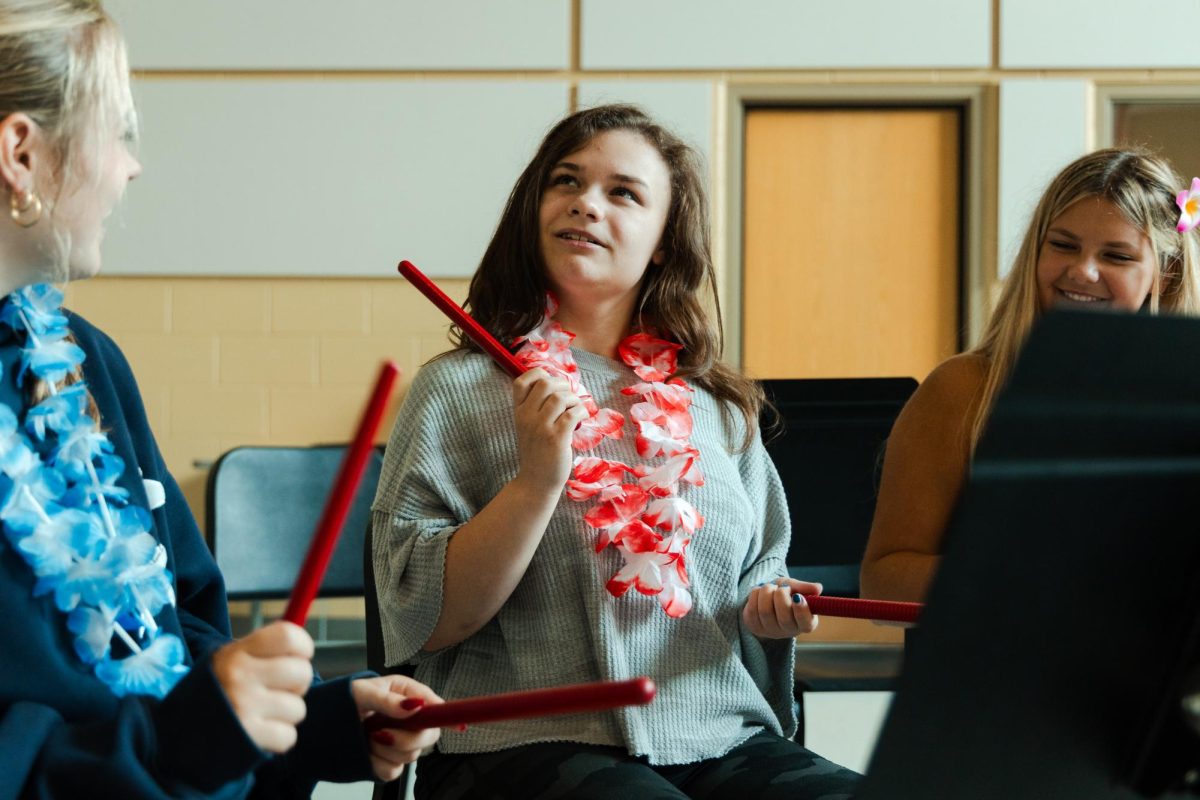 Senior Makenzie James taps rhythm sticks alongside her peers during Central's new adapted music class.