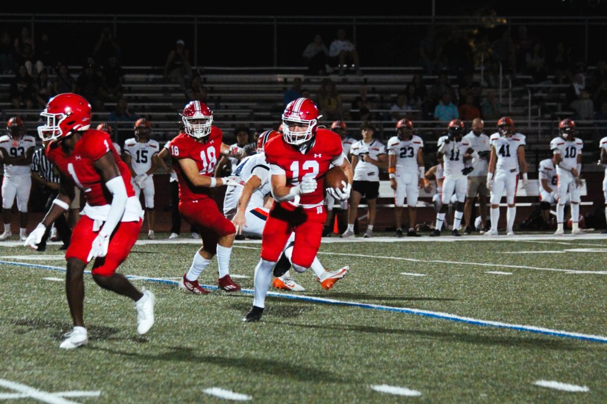 Senior Garrett Nichols runs the ball downfield during Central's homecoming game against Stagg on Sept. 20. The Redhawks dominated Stagg in a 56-7 running-clock victory.