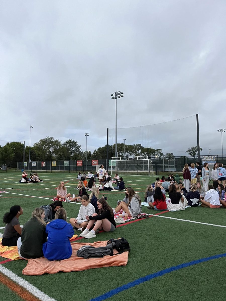 Seniors enjoy complementary Dunkin’ refreshers, coffee and donuts at
Senior Sunrise as an overcast sky covers them on Aug. 30 at the Knoch
Park turf field.