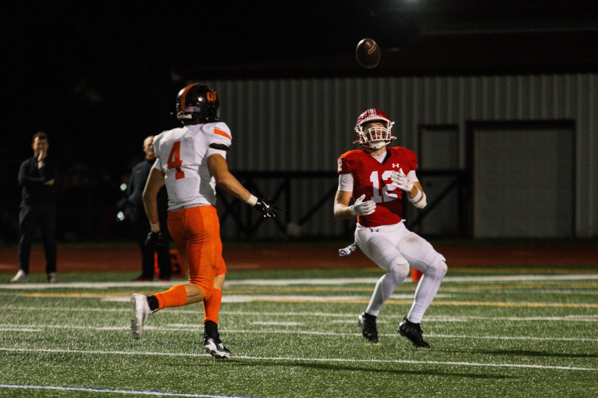 Senior Garrett Nichols (12) receives the ball downfield against Lincoln-Way West on Sept. 27.