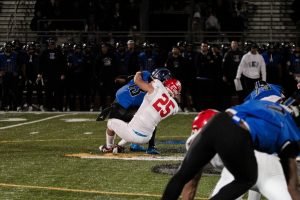 Senior Nathan Czachor (25) brings down Lincoln-Way East quarterback Jonas Williams. Central's 8-0 undefeated run ended in a 28-7 loss to Lincoln-Way, who ended the season 9-0.