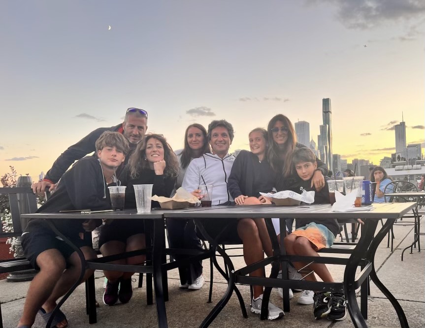 The Chicago skyline glows behind Carera and his family at a rooftop restaurant. (Photo courtesy of Edoardo Carera)