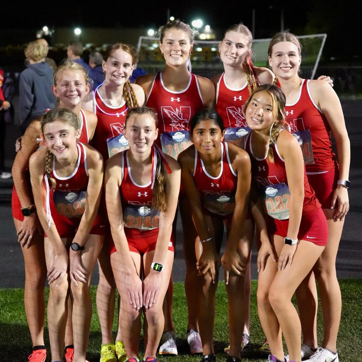 Members of Central's girls cross country varsity team pose after completing their race at the Naperville Twilight Invitation, held at Naperville North on Oct. 9. The team placed ninth among 17 teams. (Photo Credit: @nchstrackxc via Instagram)