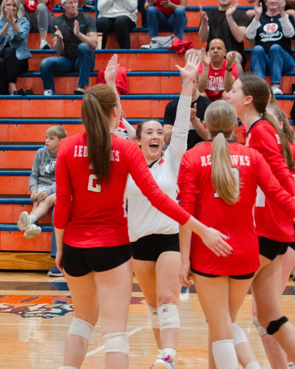 After scoring a point against the Huskies, senior Kate Torti (10) celebrates with her team on Oct. 29 at Naperville North.