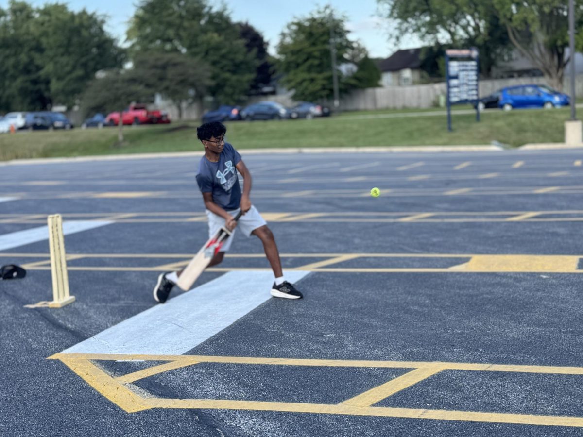 Sophomore Sreeram Potnuru swings at a ball during SASA's cricket match against Naperville North on Monday, Sept. 30.