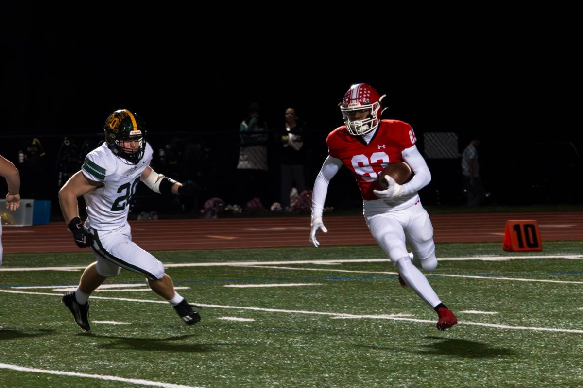 Sophomore Jermaine Kenady rushes downfield during the Redhawks’ game against William Fremd High School on Nov. 8. With Central’s 31-28 win, they advanced to the IHSA 8A Quarterfinals.