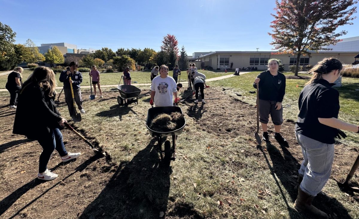 Humanities Capstone students work to skim sod and turn over soil, planting 37 different species of trees on Oct. 18