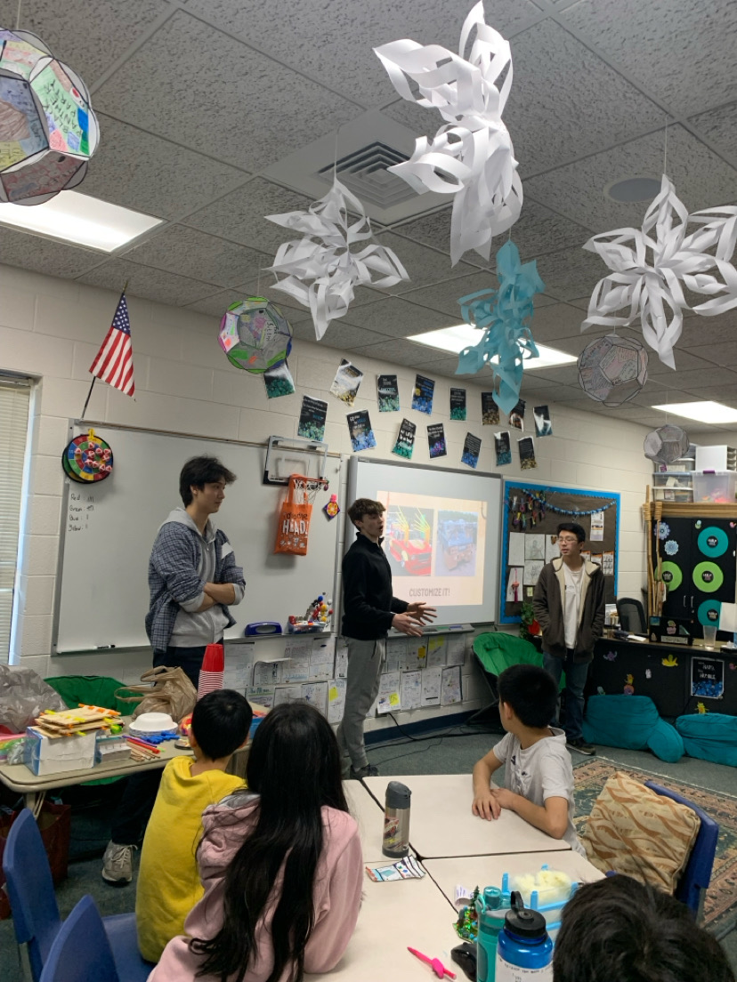 Central seniors Isaac Merz (left), Hunter Ernst (middle) and Kevin Hsu (right) give a presentation during one of Community Anchor's sponsored initiatives. (Photo courtesy of Andrew Lazovski)