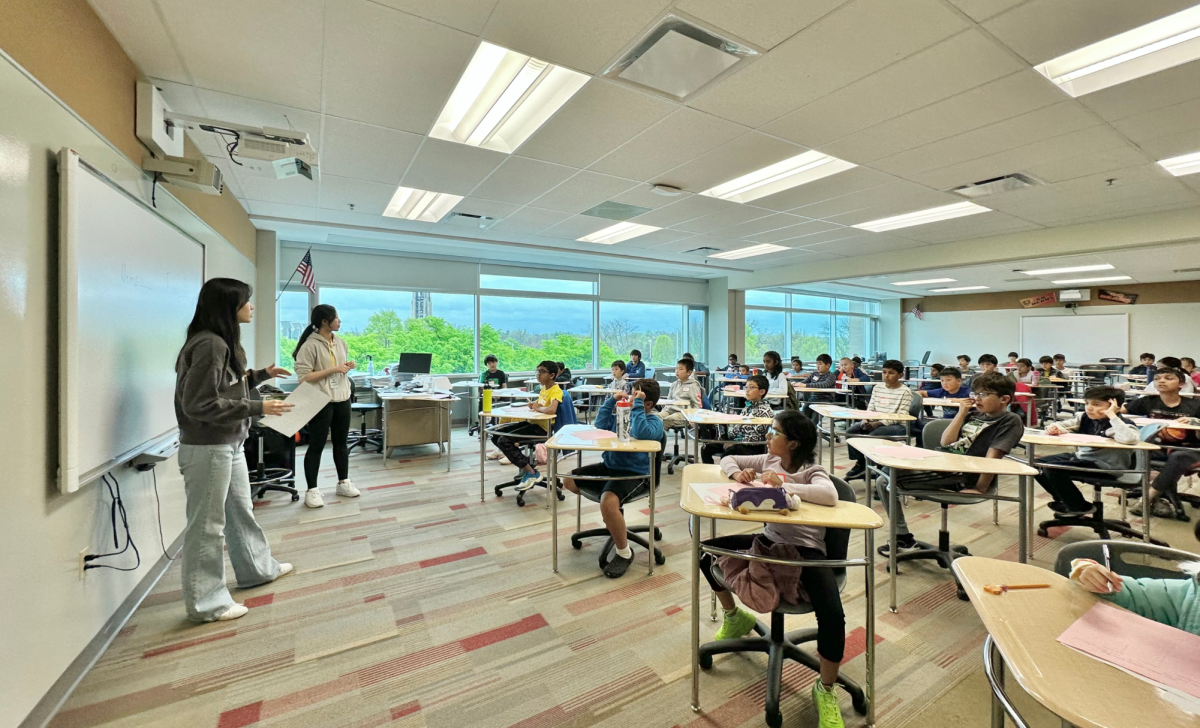 Then-sophomores Lilly Jia (far left) and Audrey Cheng (left) instruct competitors at Clover Math’s elementary and middle school math competition, hosted at Central on April 26. (Photo courtesy of Arthur Xu)