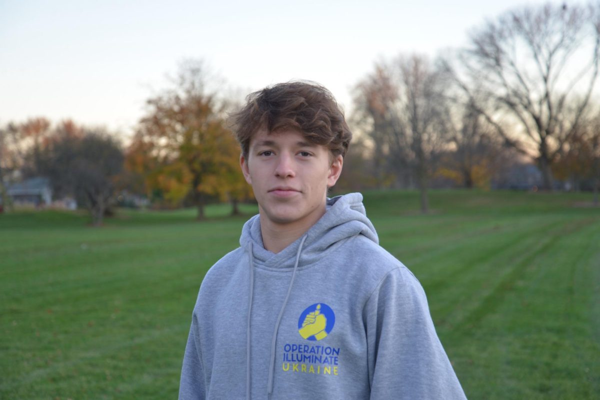 Andrew Lazovski poses for a photo in an "Operation Illuminate Ukraine" sweatshirt. The nonprofit project, founded by Andrew Lazovski, provided $35,000 in humanitarian aid to the Kherson region in Ukraine. (Photo courtesy of Andrew Lazovski)