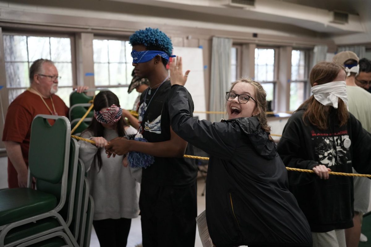 Senior Lilly Korbal waves her hand in front of an oblivious student attending Operation Snowball during an activity called "Amazing." Korbal led the workshop where members are blindfolded and have to navigate a maze in a line using a rope (Photo courtesy of Lilly Korbal). 