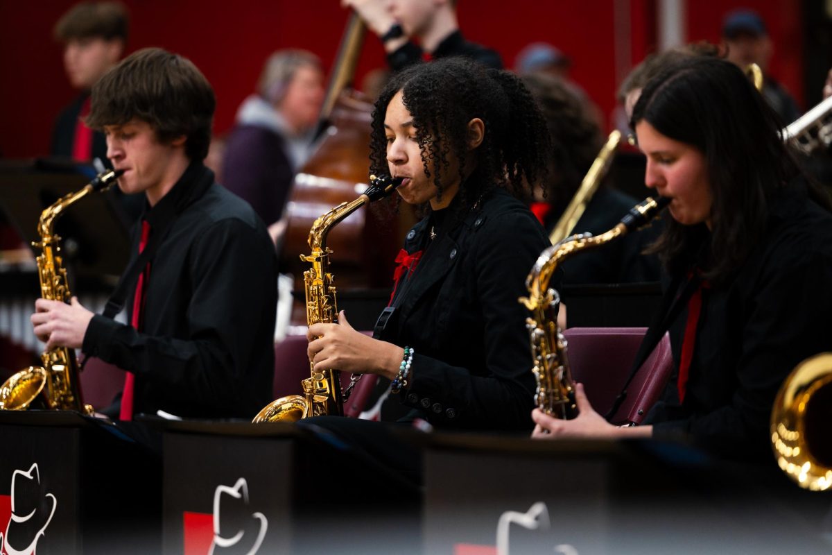 Deana Wilson (middle), Junior, played the saxaohone during the eighth grade orientation at Naperville Central on Feb. 15. She played in Central’s Jazz Studio Orchestra, which she joined this year. 