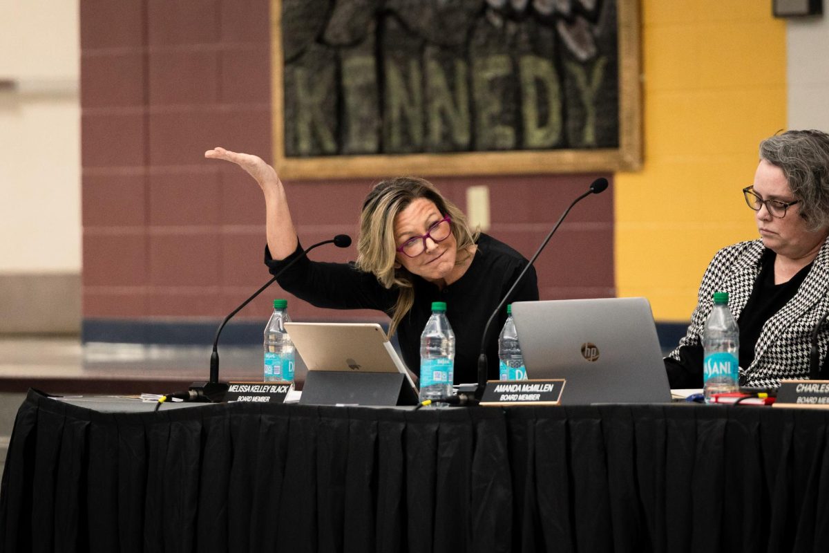 Board member Melissa Kelley Black raises her hand to speak during a Jan. 21 Board of Education meeting at Kennedy Junior High School. Discussions over Kelley Black's conduct led to numerous personal accusations among board members.