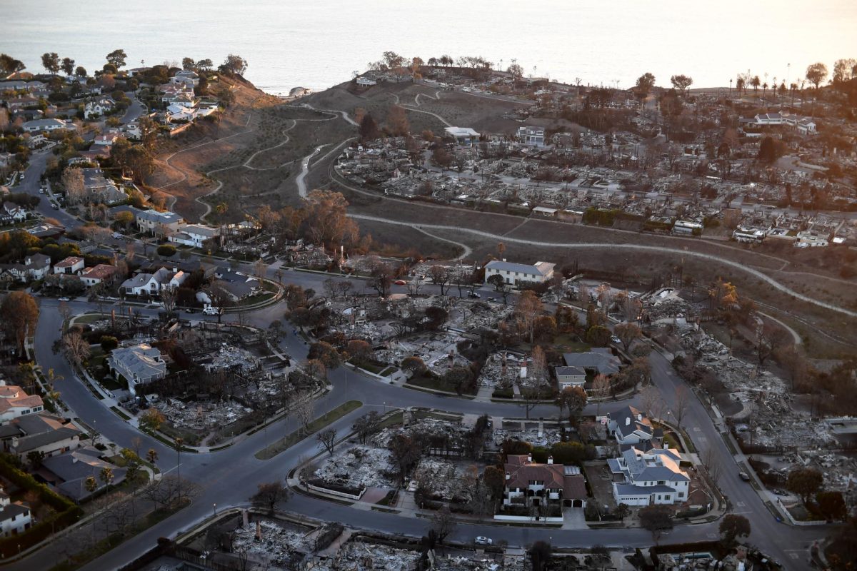 Neighborhoods sit destroyed by the Palisades Fire in areas near Pacific Palisades, California on Jan. 14, 2025. The January 2025 California wildfires started early in the year, similar to wildfires that plagued much of early 2020. (Photo credit: Sgt. 1st Class Jon Soucy via Flickr)