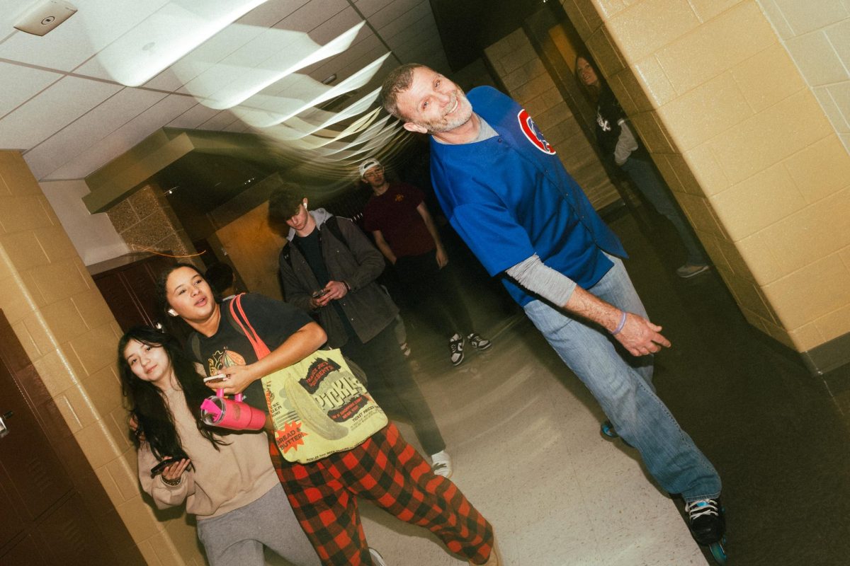 Todd Holmberg skates past students during passing periods. Holmberg uses skating to break societal norms as a way to teach his anthropology class about folkways and mores. 