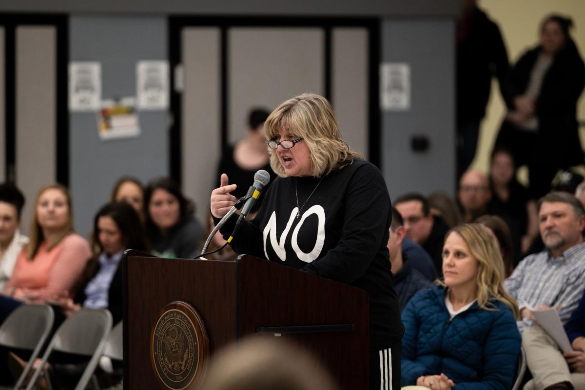 Anne Marie Tomek, a District 203 junior high P.E. teacher, speaks at the Feb. 3 Board of Education meeting at Kennedy Junior High School against proposed school day changes. The changes include shifted start and end times, as well as a shift to a modified block schedule at the high school level. 