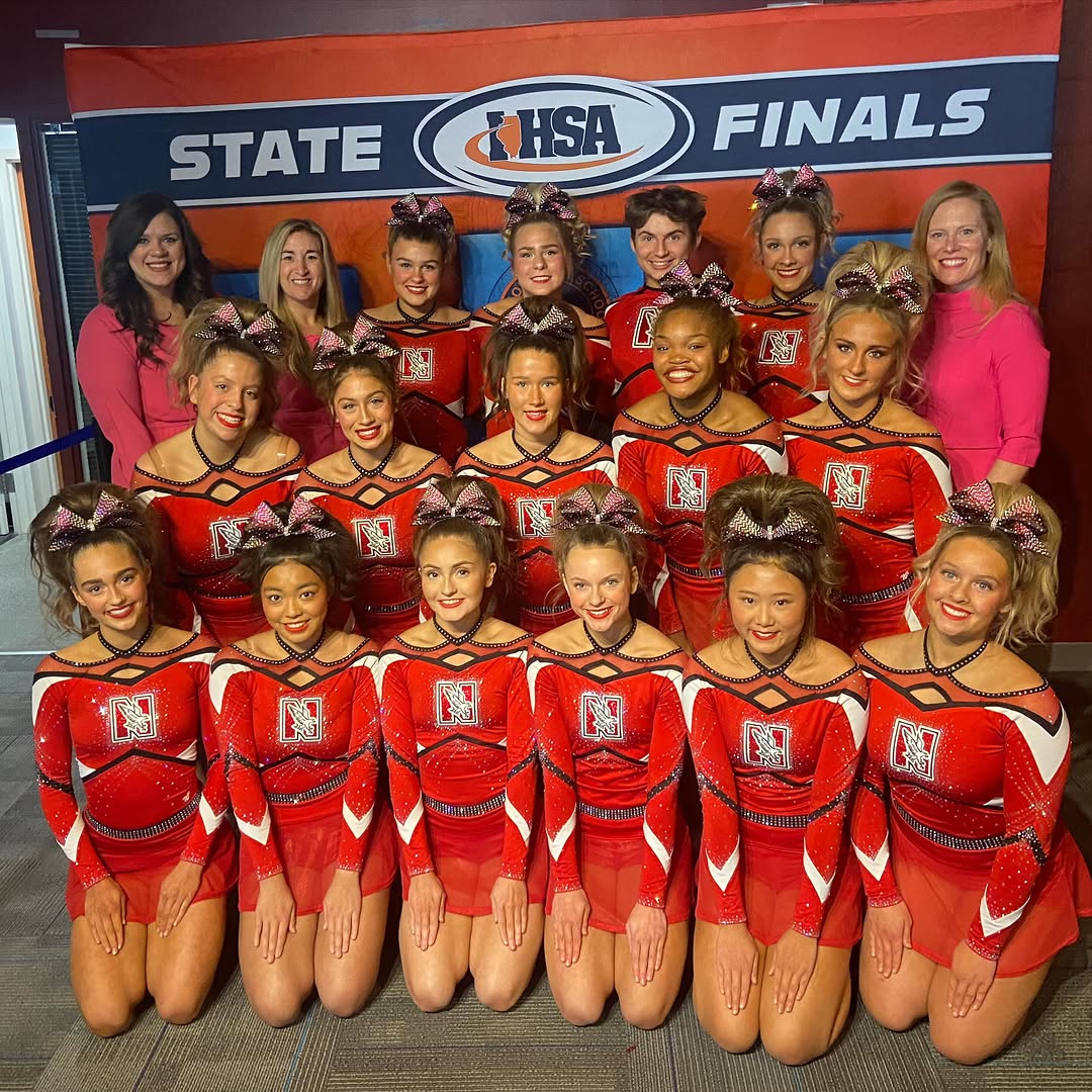 The cheer team poses at IHSA State Finals on Feb. 7. They placed 11th overall, missing the top 10 finals cutoff by 0.06 points. (Photo Credit: nchsredhawkcheer via Instagram)