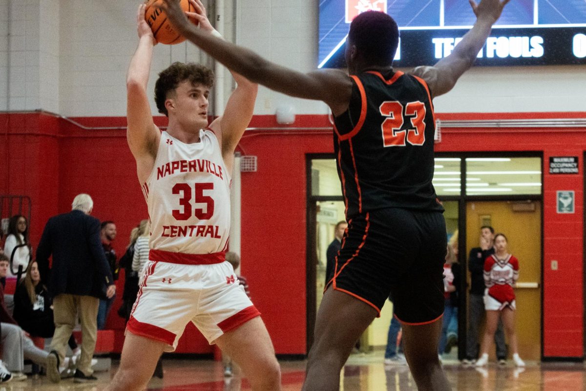 Senior Connor Sands looks for an open teammate in a game against DeKalb on Feb. 7. Central went on to lose the conference game 44-56. 