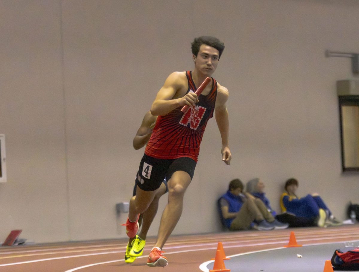 Junior Connor Marvin runs a relay as the anchor on Feb. 20 at the North Central College Boys Indoor Invitational. Central walked away with 106.5 points in total, leading them to a first place victory. 