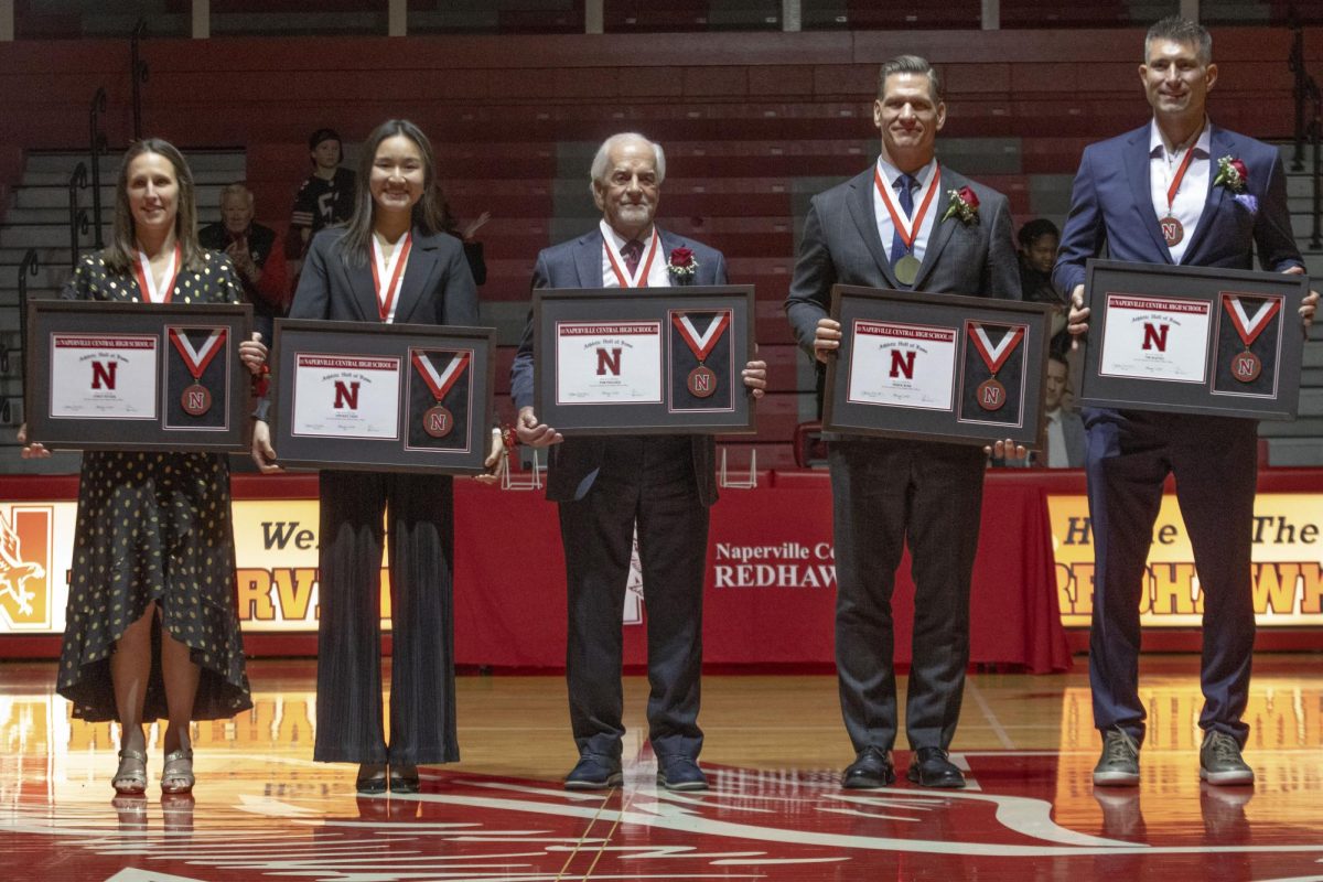 Five inductees pose for a photo during the induction ceremony hosted in the main gym on Feb. 7. The ceremony was followed by a basketball game against DeKalb. 